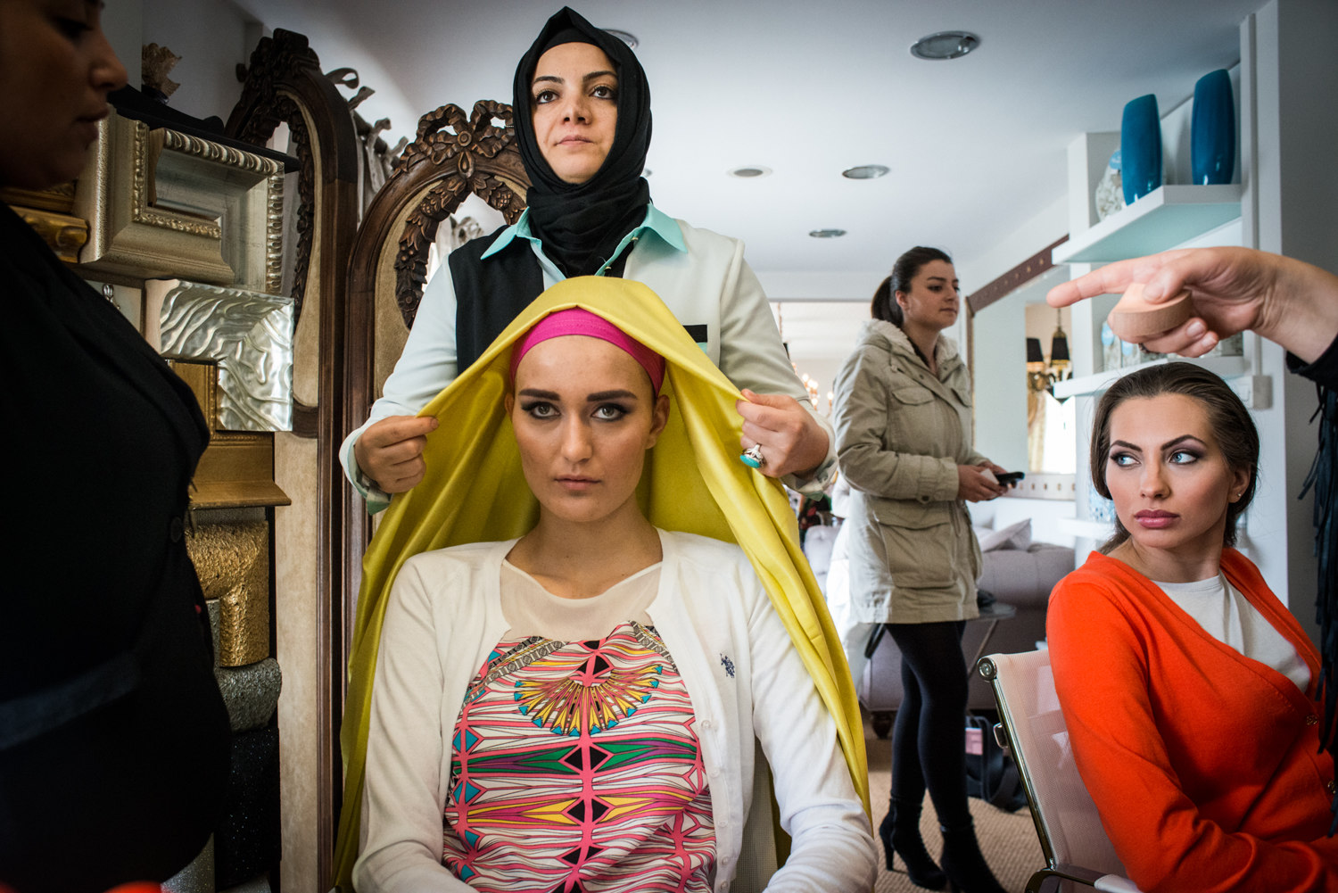  Models are made up before a shoot for ALA Magazine, the first magazine in Turkey for conservative women. Preparations include full make-up and headscarves- layered for a pop of color. 