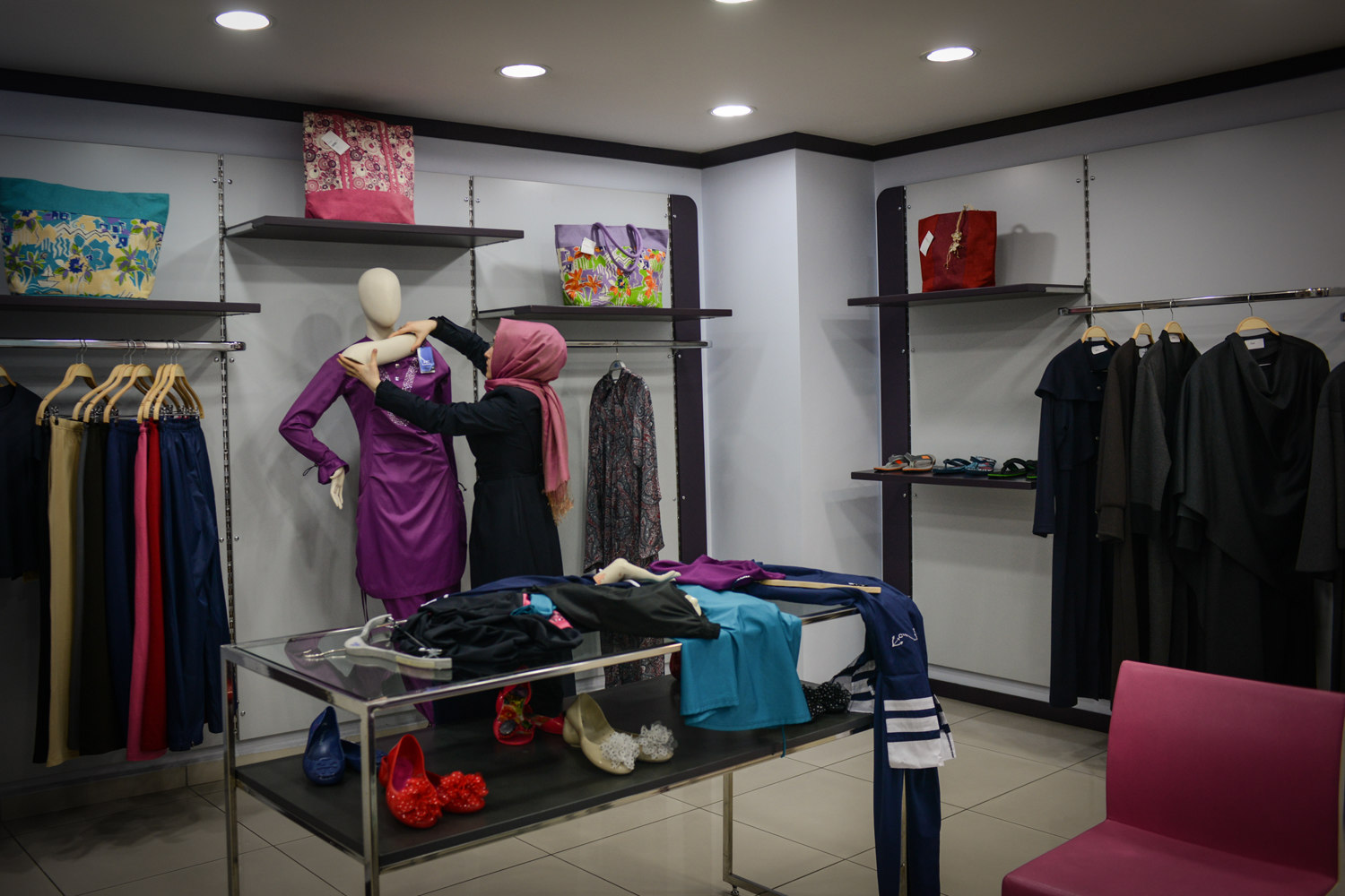  A woman dresses a mannequin at the Hasema swimwear store in Fatih, Istanbul. Hasema is one of the main manufacturers of conservative bathing-suits and have a style similar to the "Birkini". 