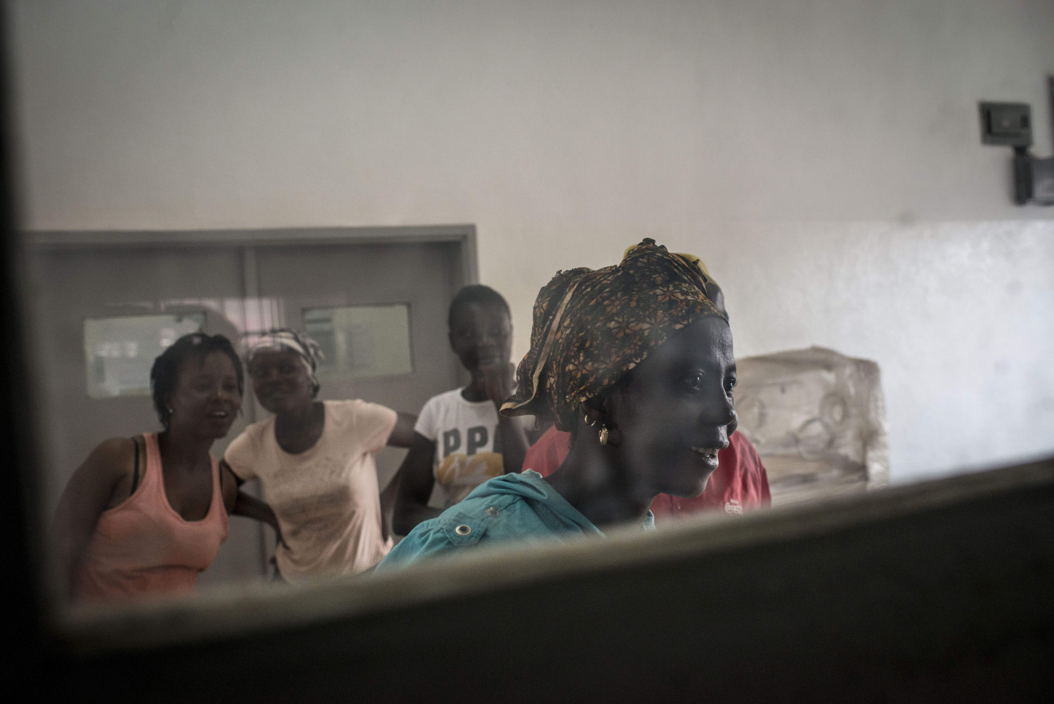  Family members peer into the delivery room at Kenema Government hospital to see how the mothers are faring in Kenema, Sierra Leone on November 10th, 2015.  