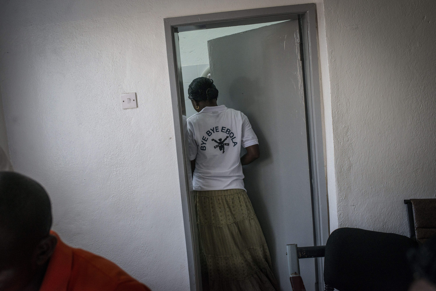  An attendant wears a shirt saying "Bye Bye Ebola". 