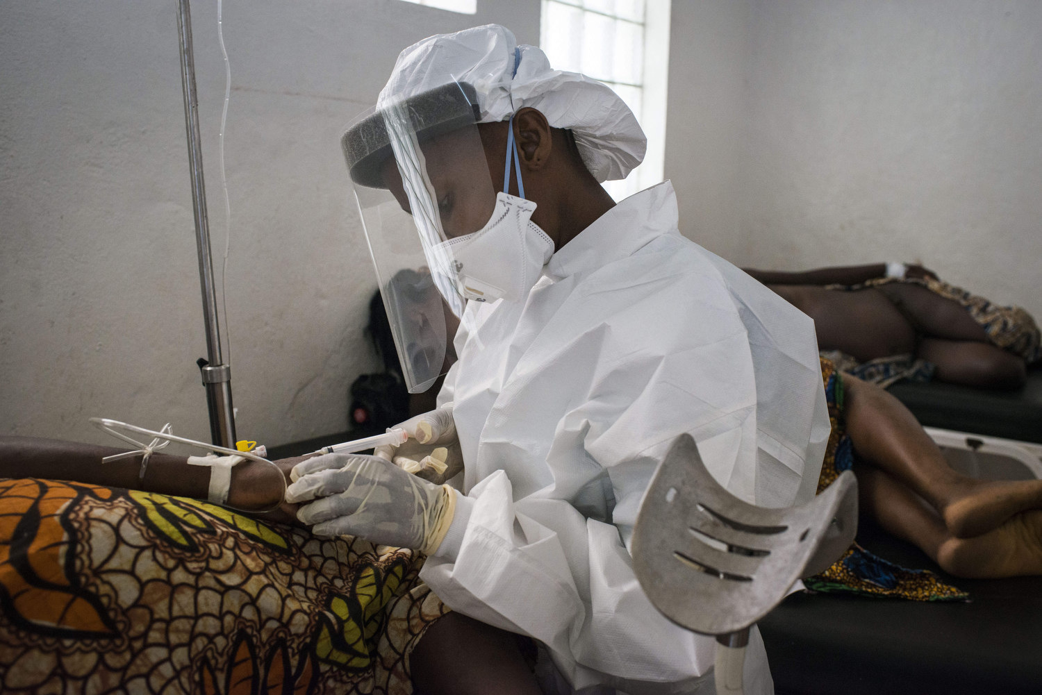  A nurse takes blood from Kema James after she delivers. Full body protection is used to collect blood samples as Ebola is still a precaution in Sierra Leone.  