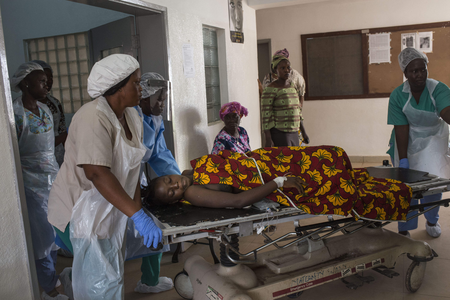  Christiana Dasama,17  is taken to surgery after giving birth due to excessive bleeding at Kenema Government Hospital in Kenema, Sierra Leone on November 11th, 2015. 
