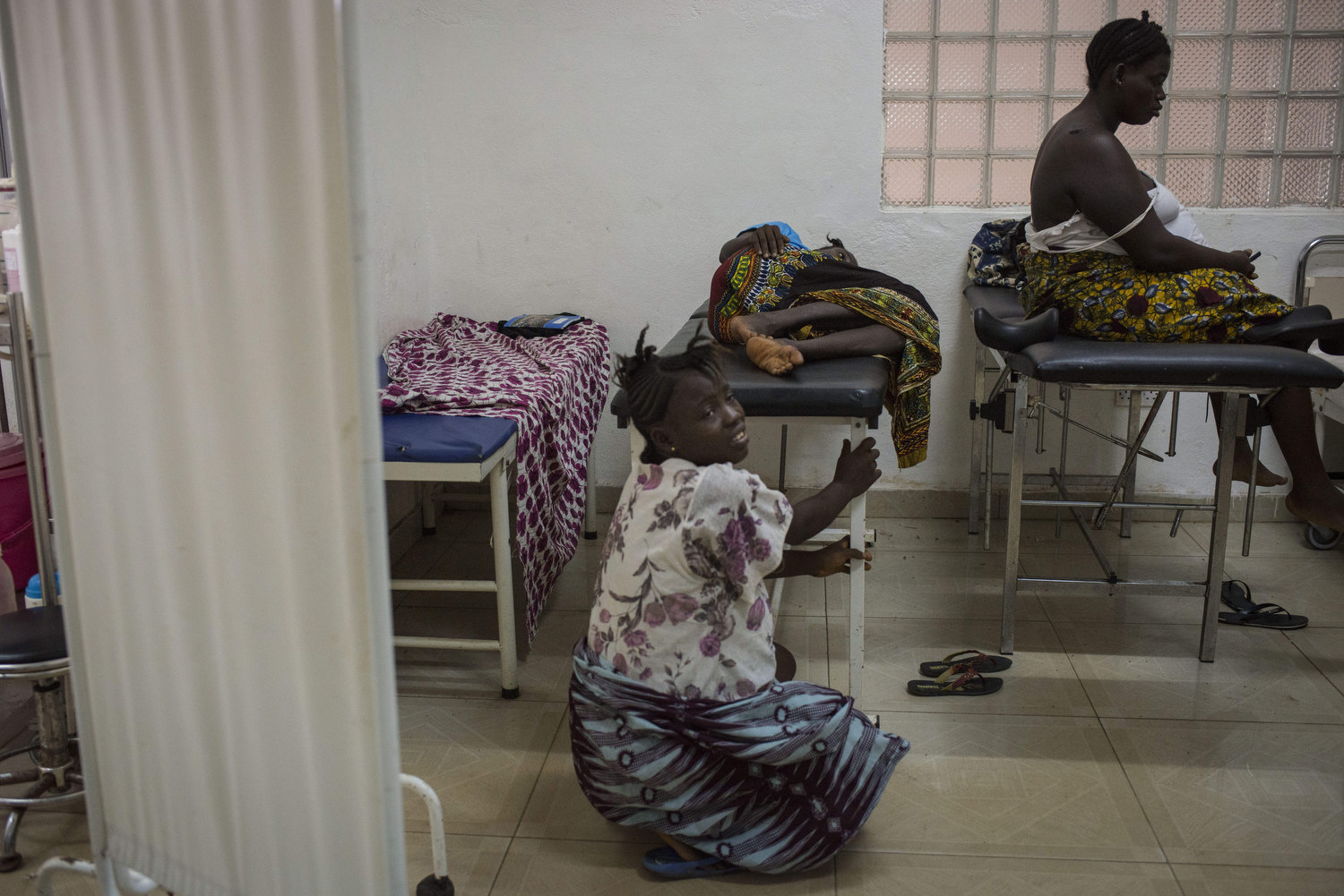  Christiana Dasama,17  is in pain as she waits to give birth at Kenema Government Hospital in Kenema, Sierra Leone on November 11th, 2015. 