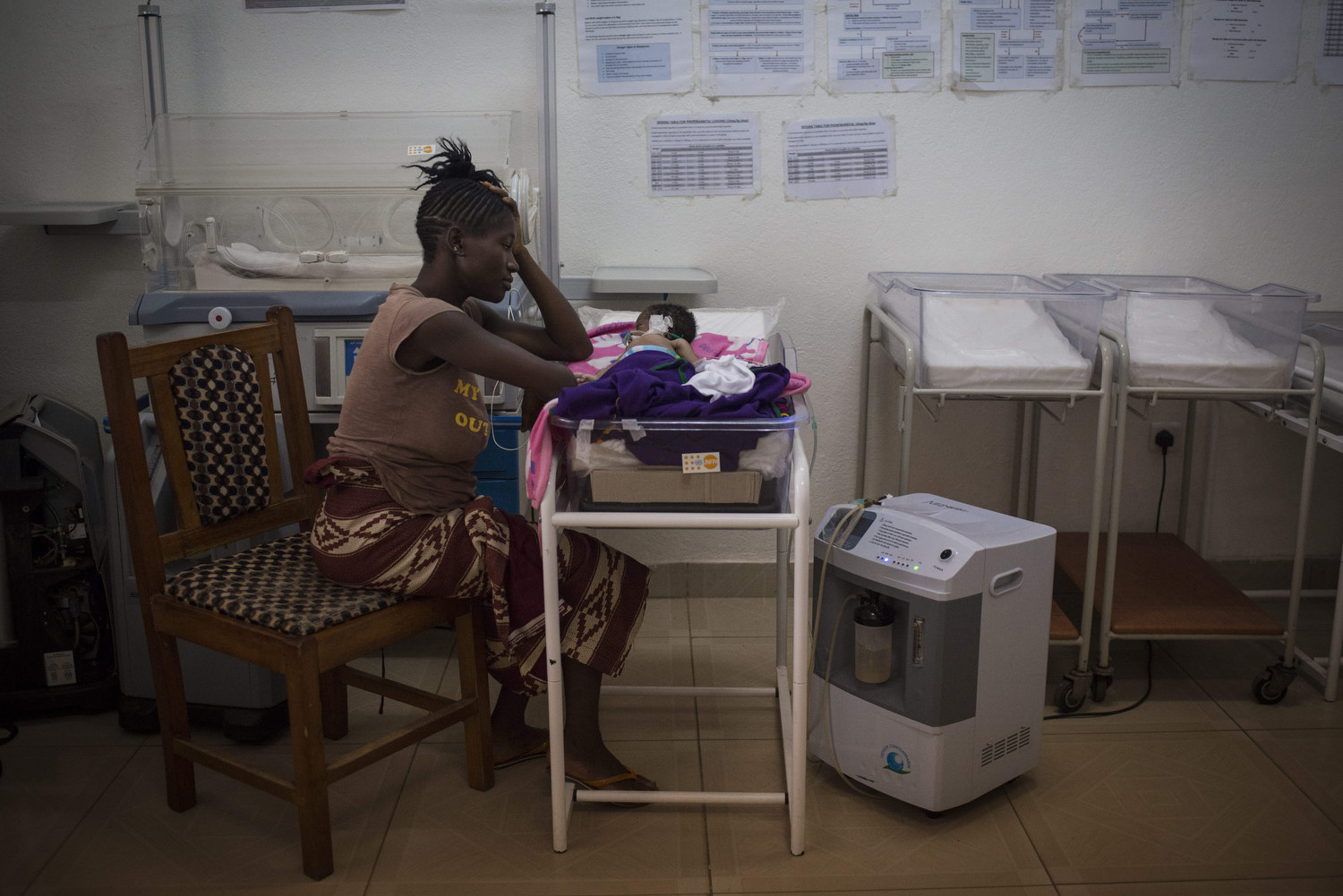  Kema watches her baby boy in the NICU ward on November 12th, 2015 three days after giving birth to the baby at Kenema Goverment Hospital in Kenema, Sierra Leone. The baby died the next day, he was five days old.  
