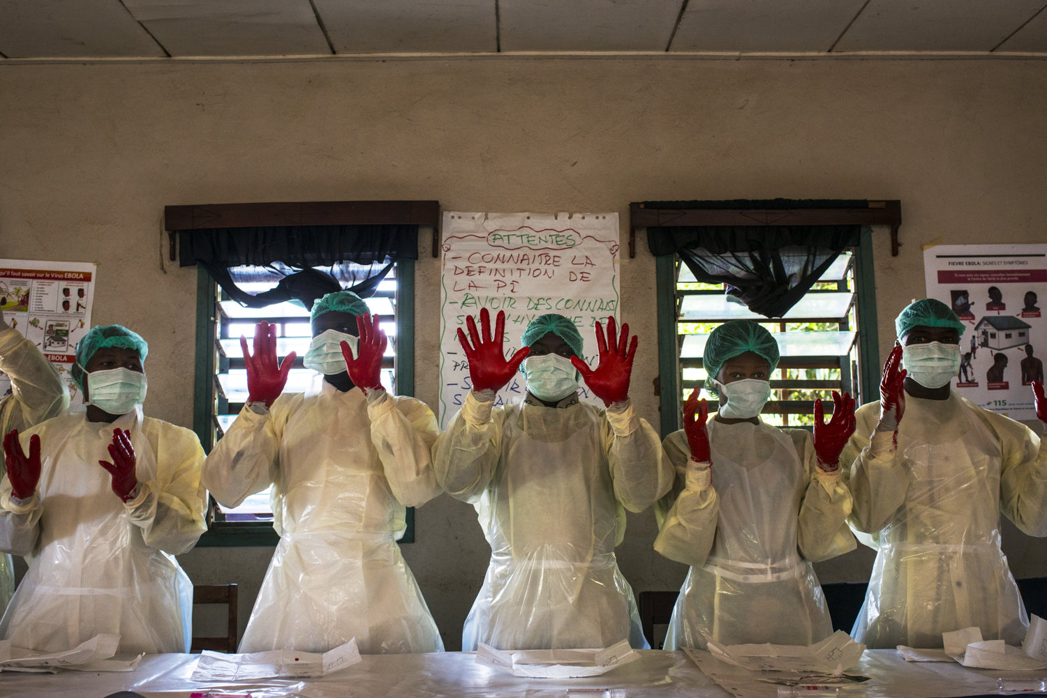  Students practice hand-washing with paint to show the spots they missed. Students are handed out protective gear to practice with on Day 2 of the JHIPAGO training. This session is led by Mrs Saran Kaba-in Faranah, Guinea on November 17th, 2015.  