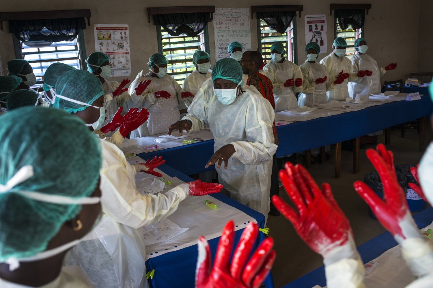  Students practice hand-washing with paint to show the spots they missed.
 