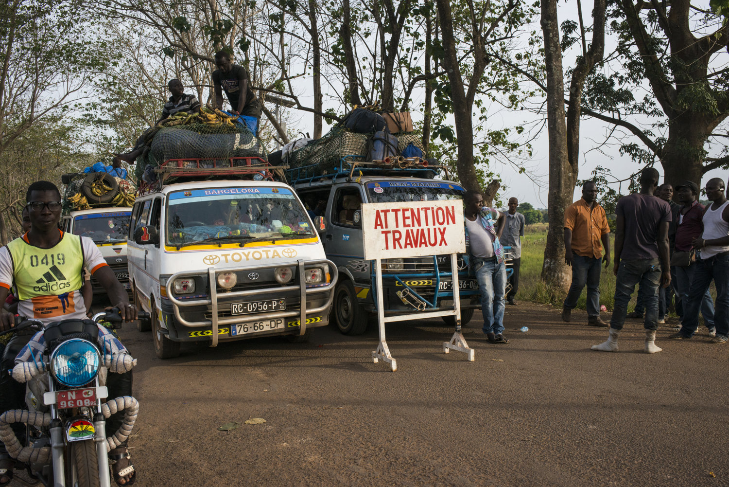  On the main road, traffic is held on a bridge while maintenance crews attend to the bridge. The bridge spans the Niger river which has a source nearby.  