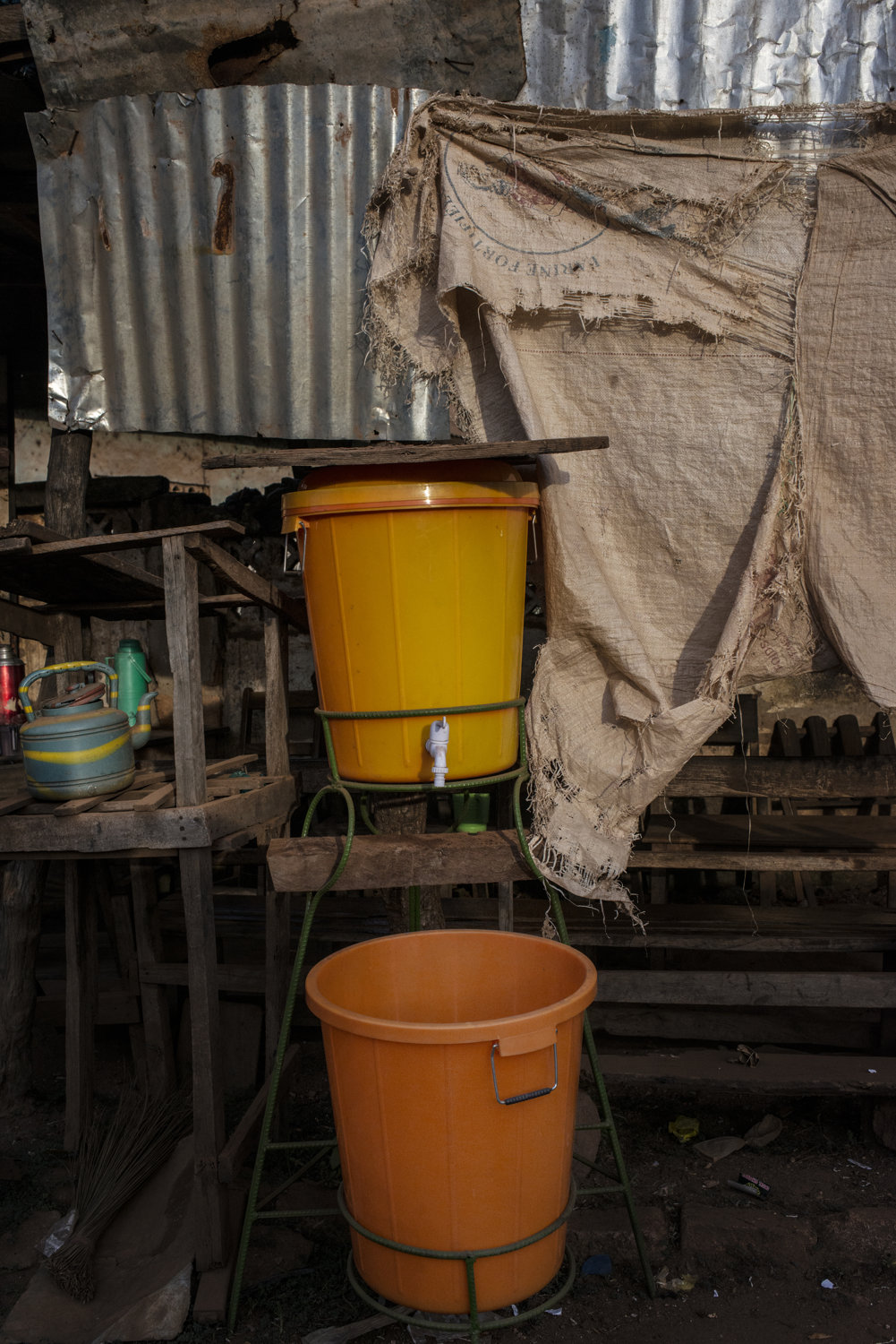  A hand washing stand near the market in Faranah, Guinea. The stands contain a mixture of bleach and water which kills germs including ebola. These colorful basins can be found throughout the country.  