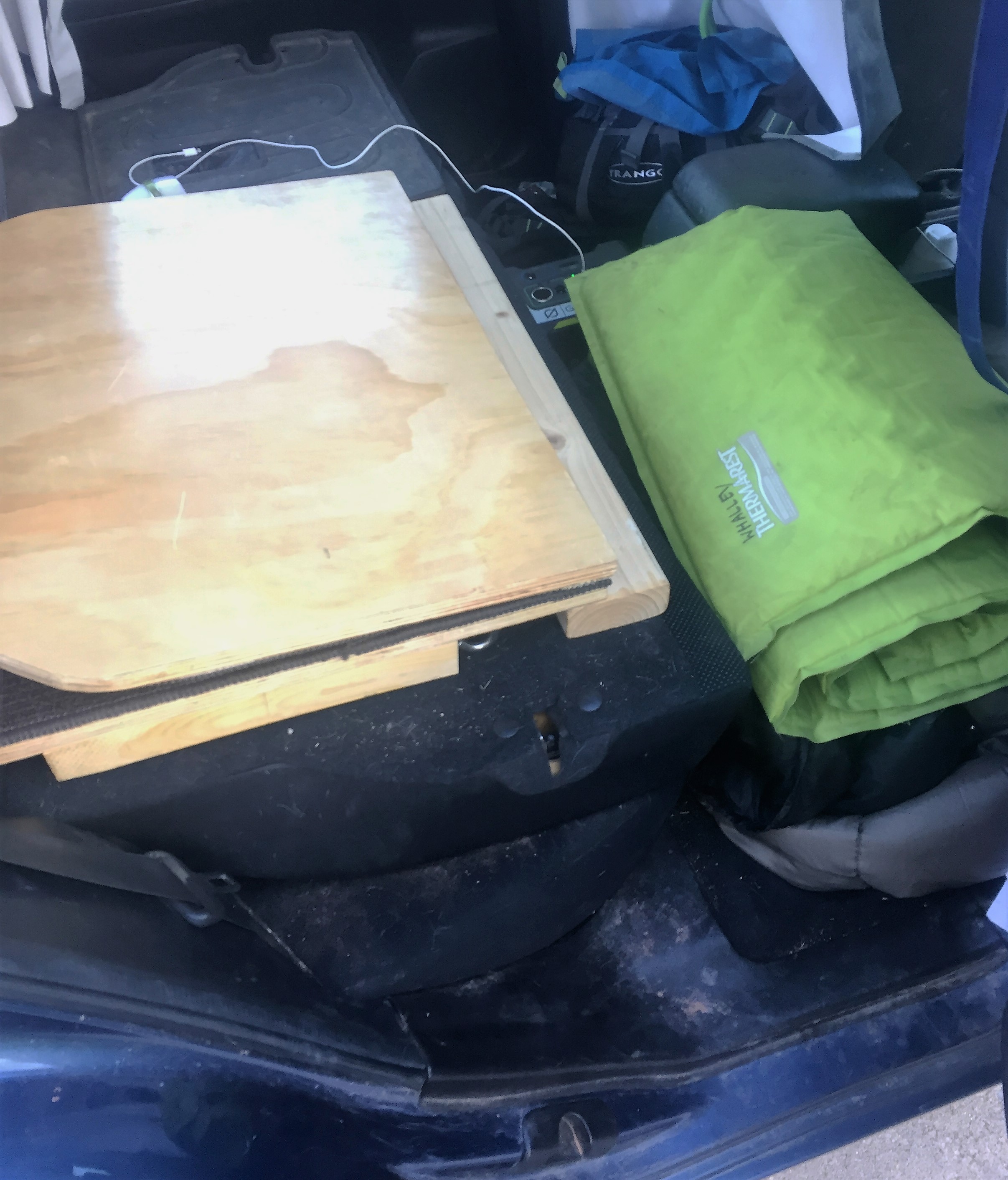 Platform folded up so front seat can slide back. Bed storage in footwell. I need to vacuum. 