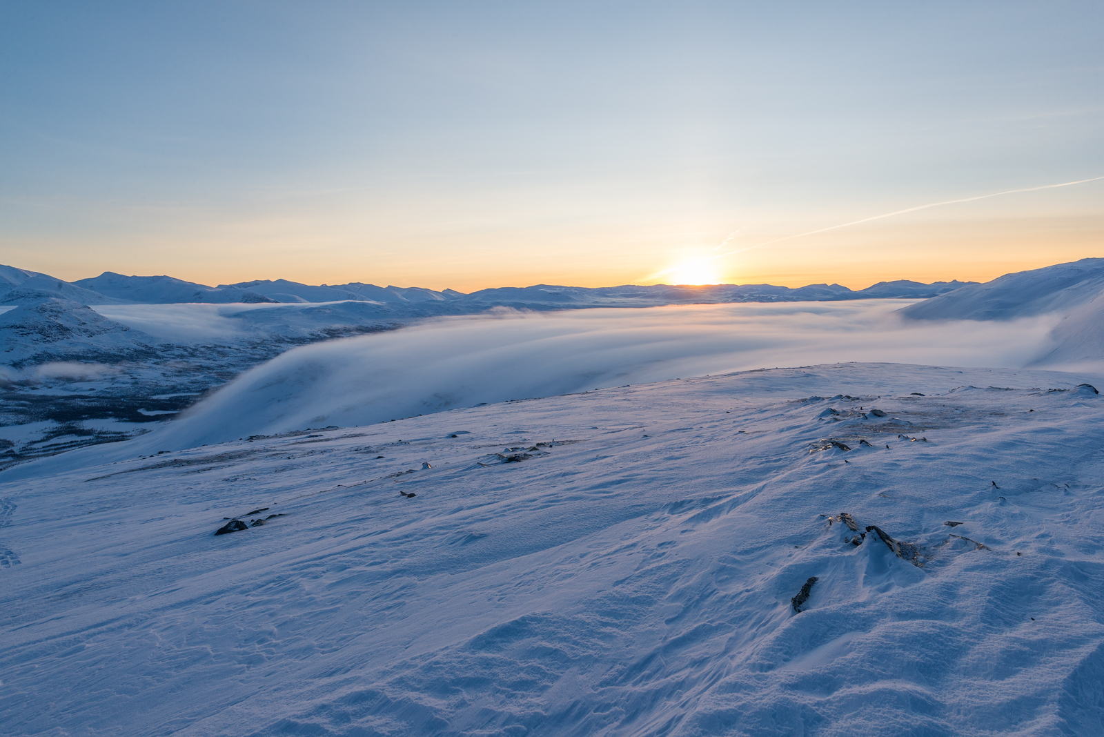Mist slowly filling the valley at sunset.