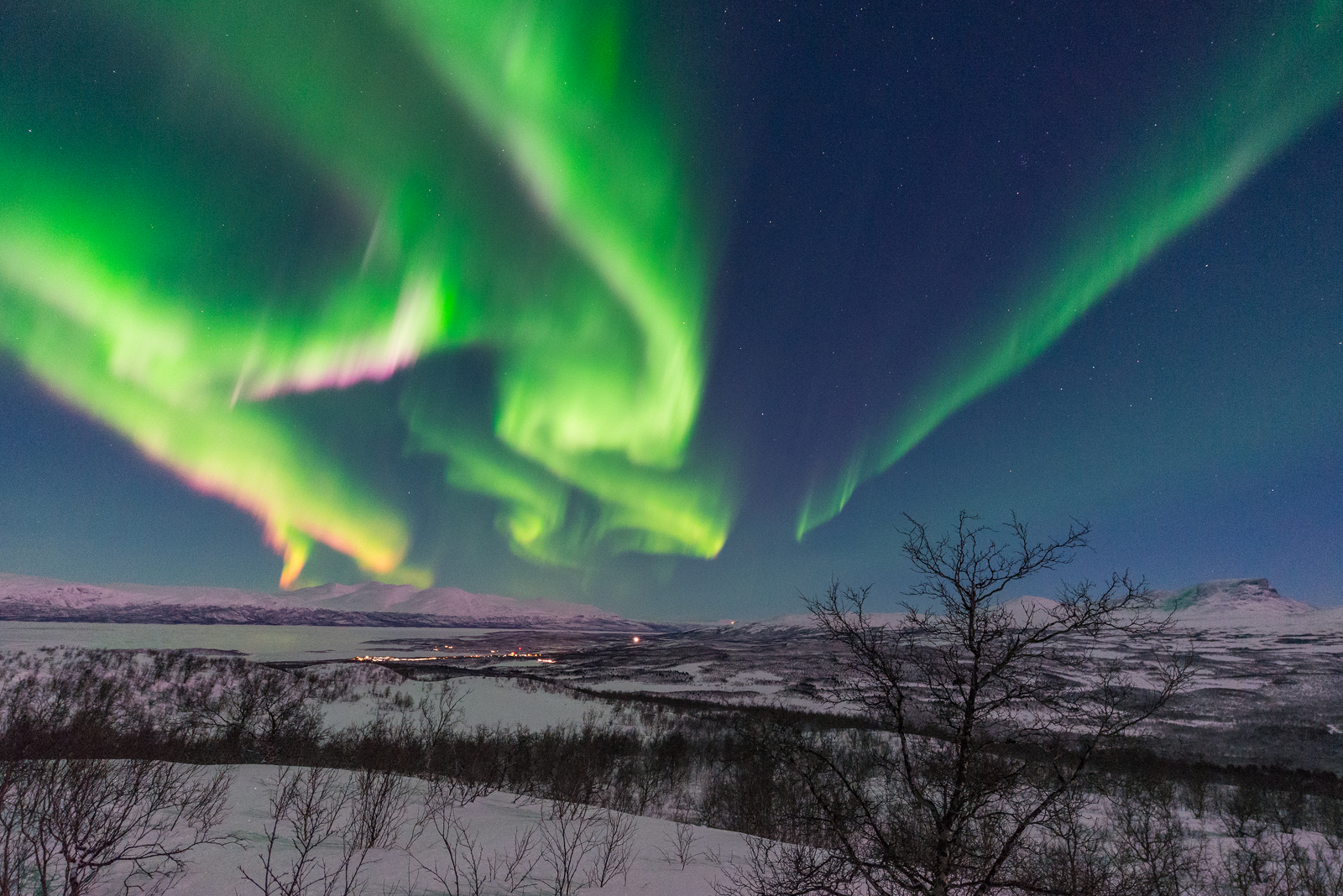 Extremely strong auroral display above the village of Abisko.