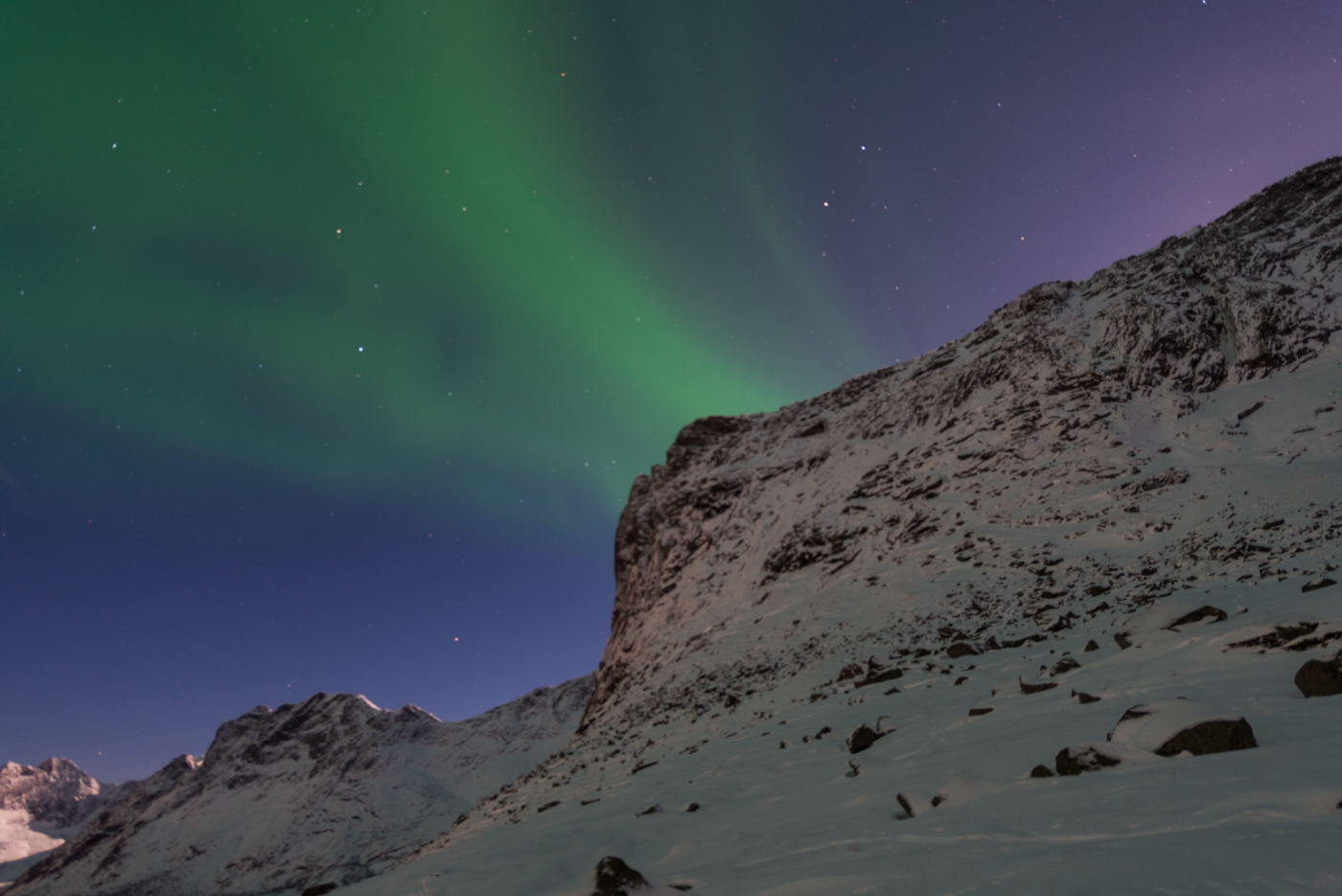 The tent at night looking over the Reinefjord and weak polar lights displaying during New Year's night.