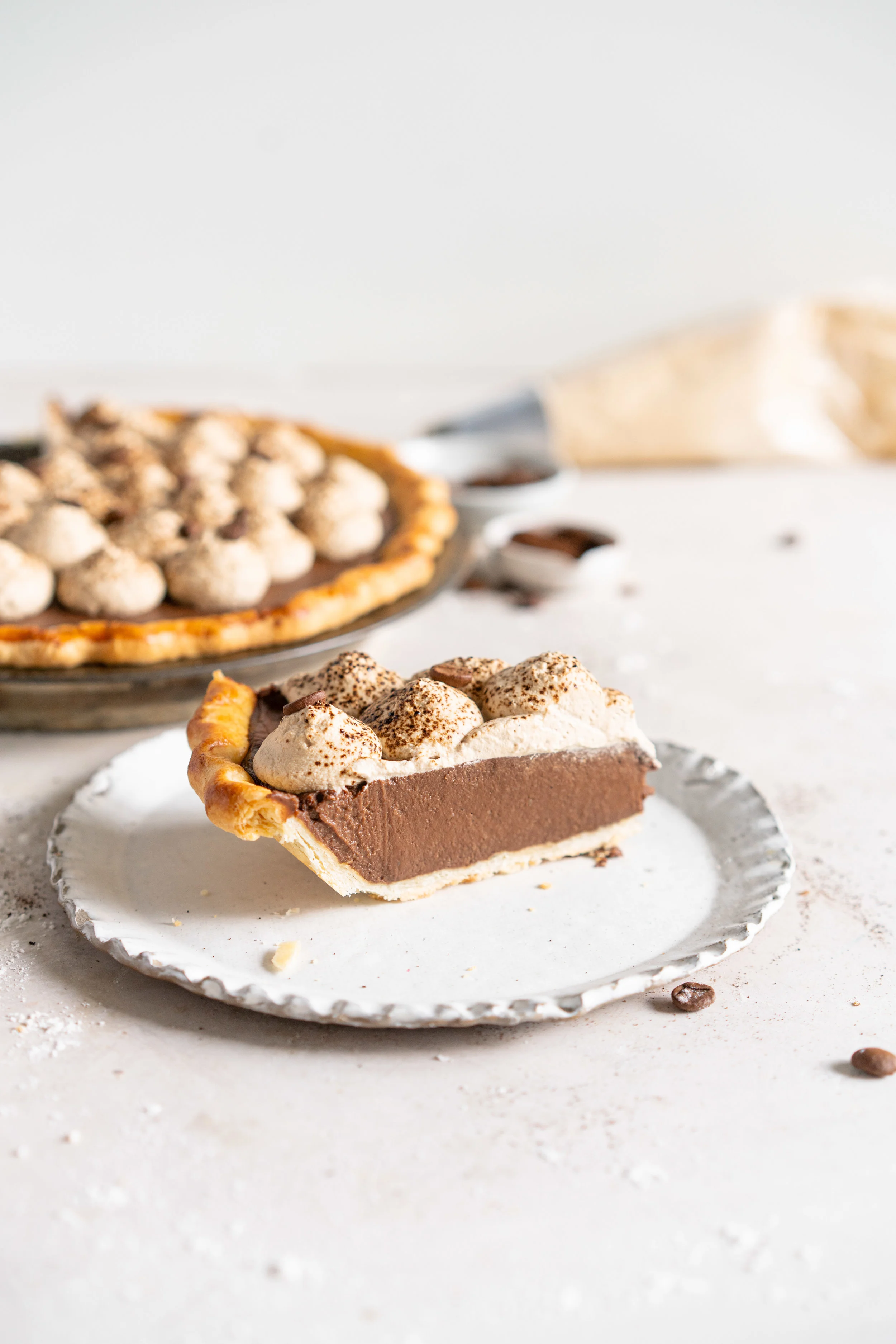 side on shot of slice of mocha cream pie with espresso whipped cream .jpg