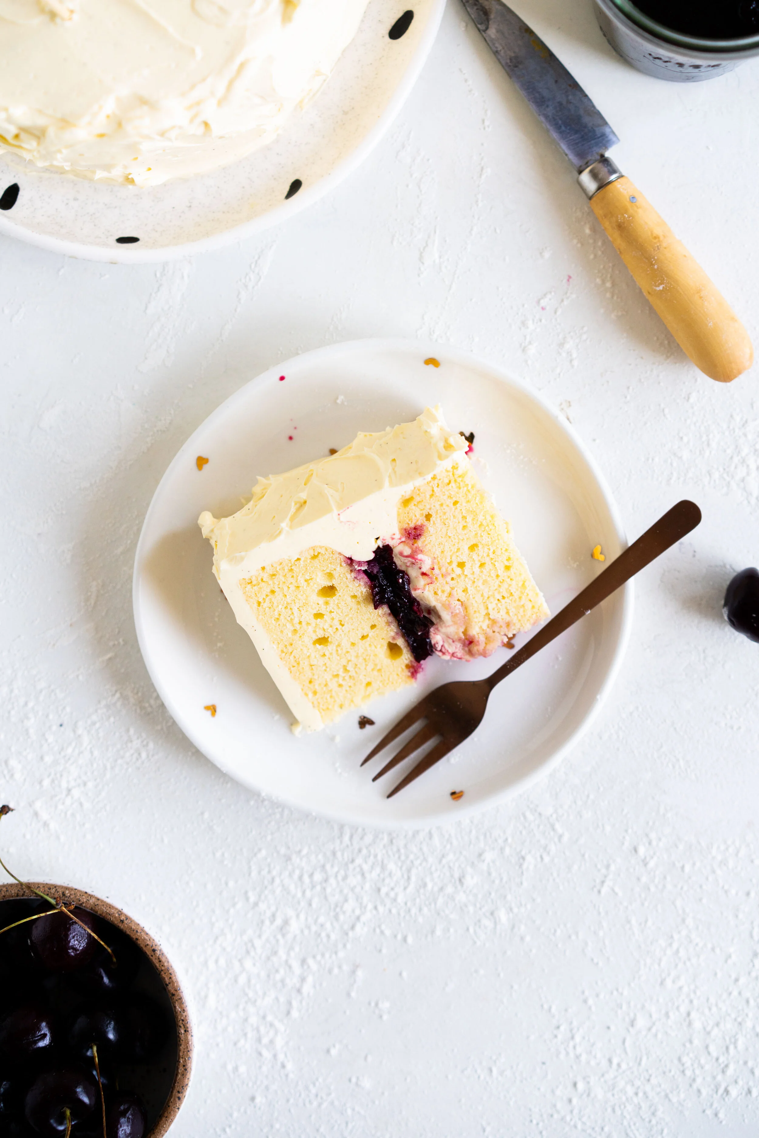 Two Layer Vanilla Bean Buttermilk Cake with Cherry Compote and Vanilla Bean Swiss Meringue