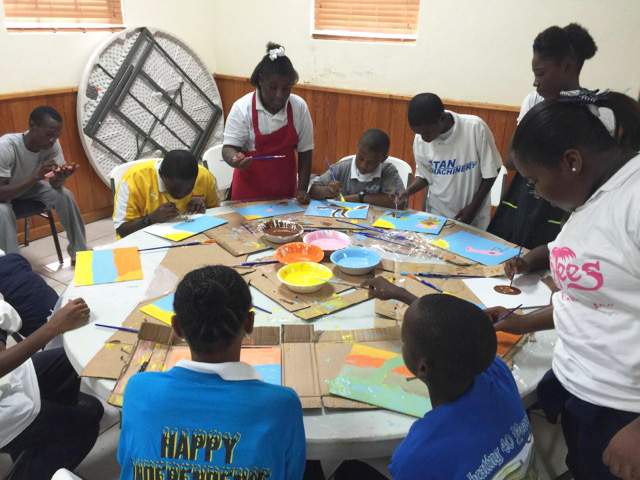 Eleutheran School children engaging in 'Paint Like Amos' workshop in parish hall. 