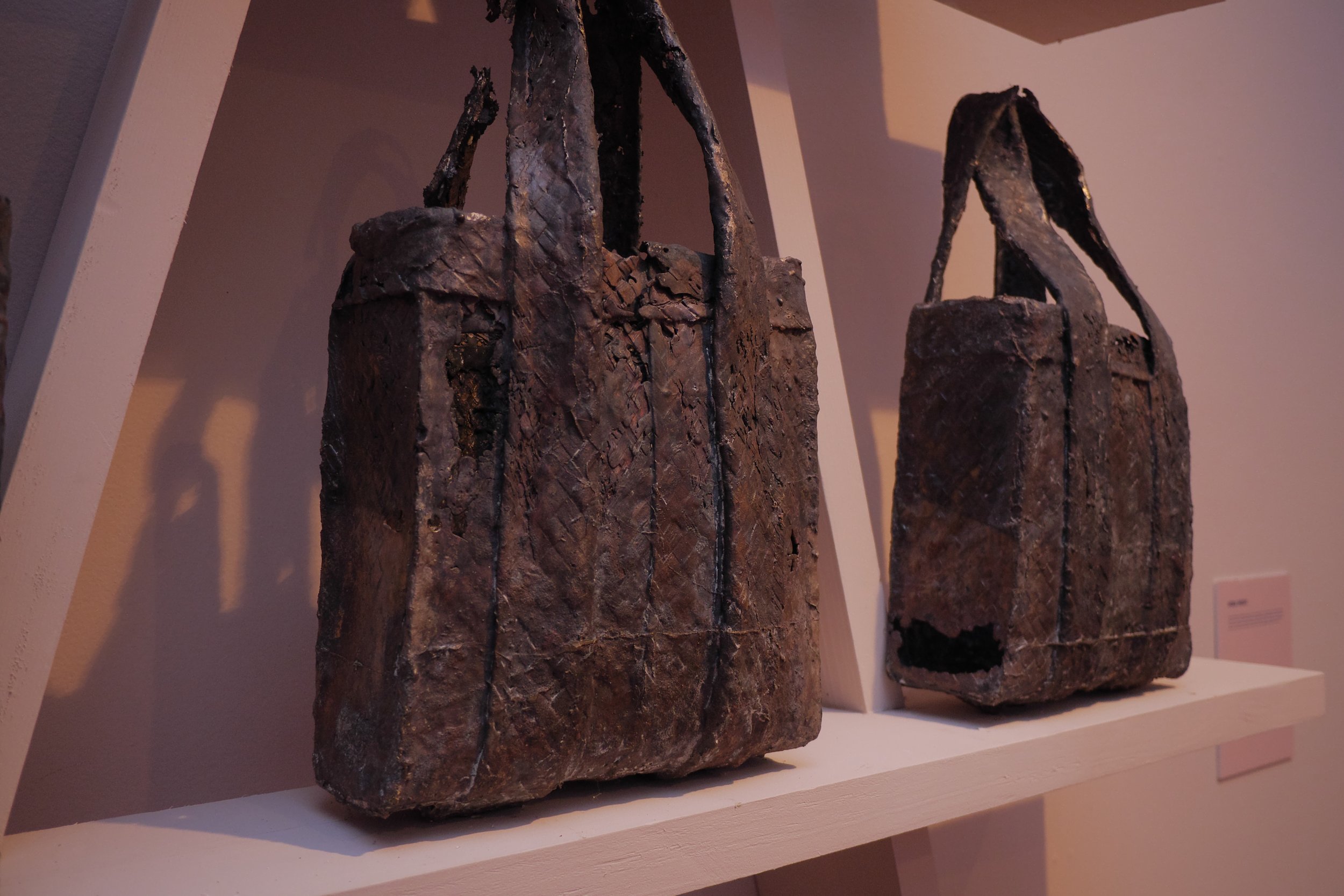 Close up of ‘Tourism Perfection 1-9’ (2016) by Averia Wright featuring straw bags cast in bronze.