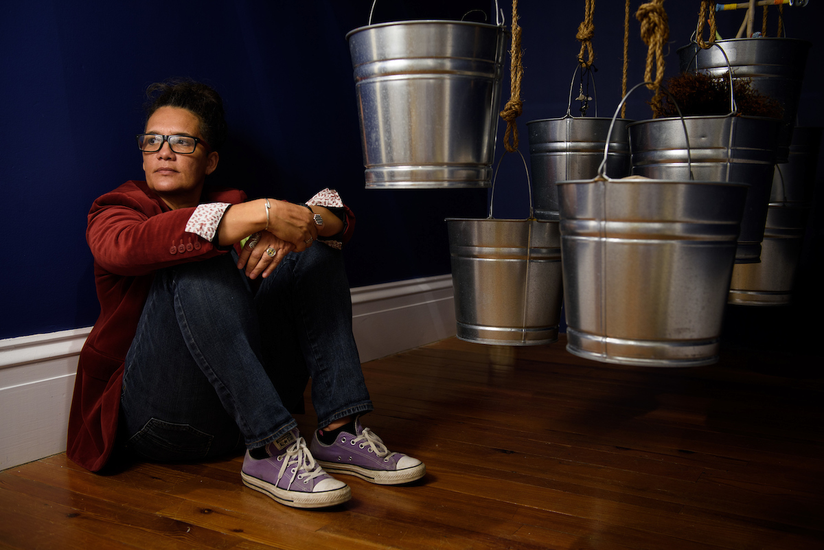 Portrait of Margot Bethel with her installation at the National Art Gallery. The work was created for the National Exhibition 8. Images courtesy of Dante Carrer.