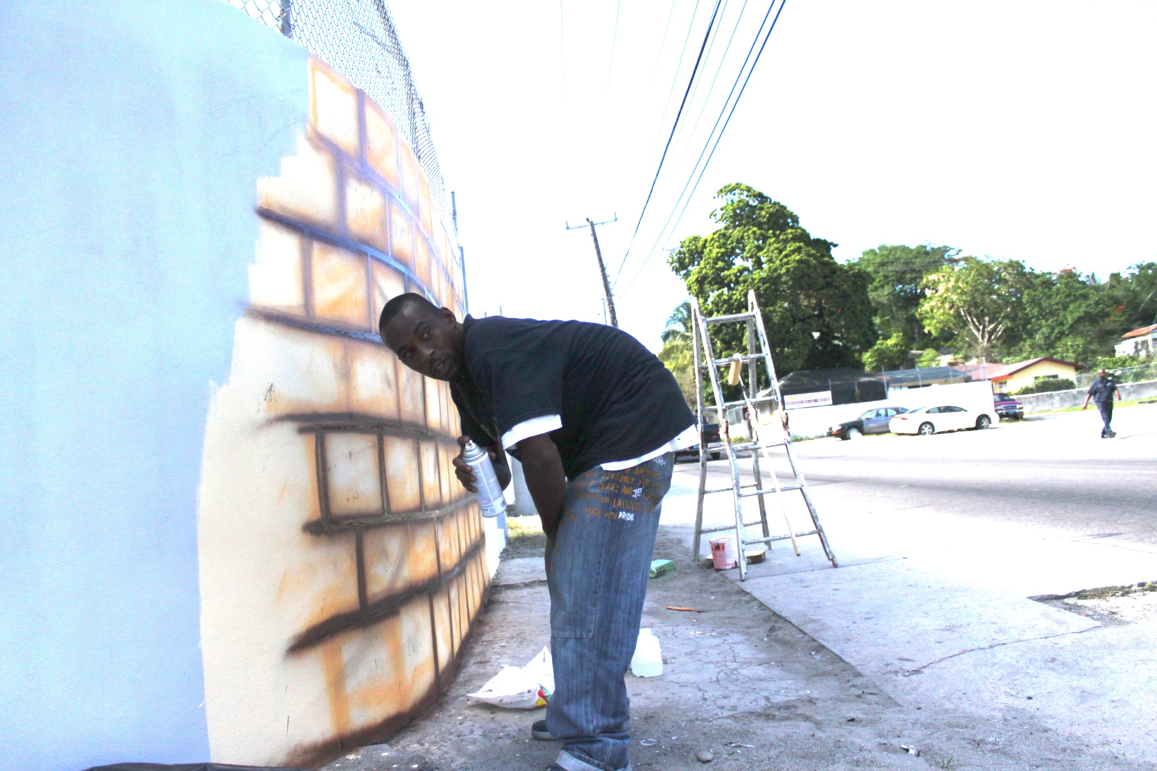 Slime working on the “Wall of Respect,” East Street and Lewis Street, 2015. All images provided by Amanda Coulson.