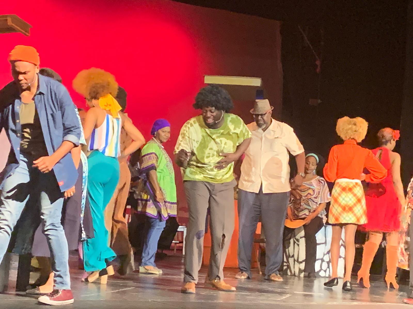 Cast from Der Real Ting, L-R Samantha Pratt, Osano Neely (Johnny), Fabienne Bailey-Brown, Anja Bowe, Gregory Deane, Ali Culmer, Sasha Major, Rose Barrett, and members of the band led by Fred Ferguson. Image courtesy of Nicolette Bethel.