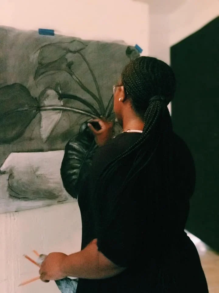 Minnis at work on a charcoal drawing of a plant. Image courtesy of the artist.