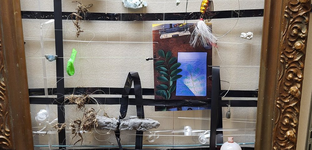 Detail of Persistence of Asteraceae. Materials shown include foam collected on the shore after a flood and the tape from a VHS found in the parking lot of the civic center