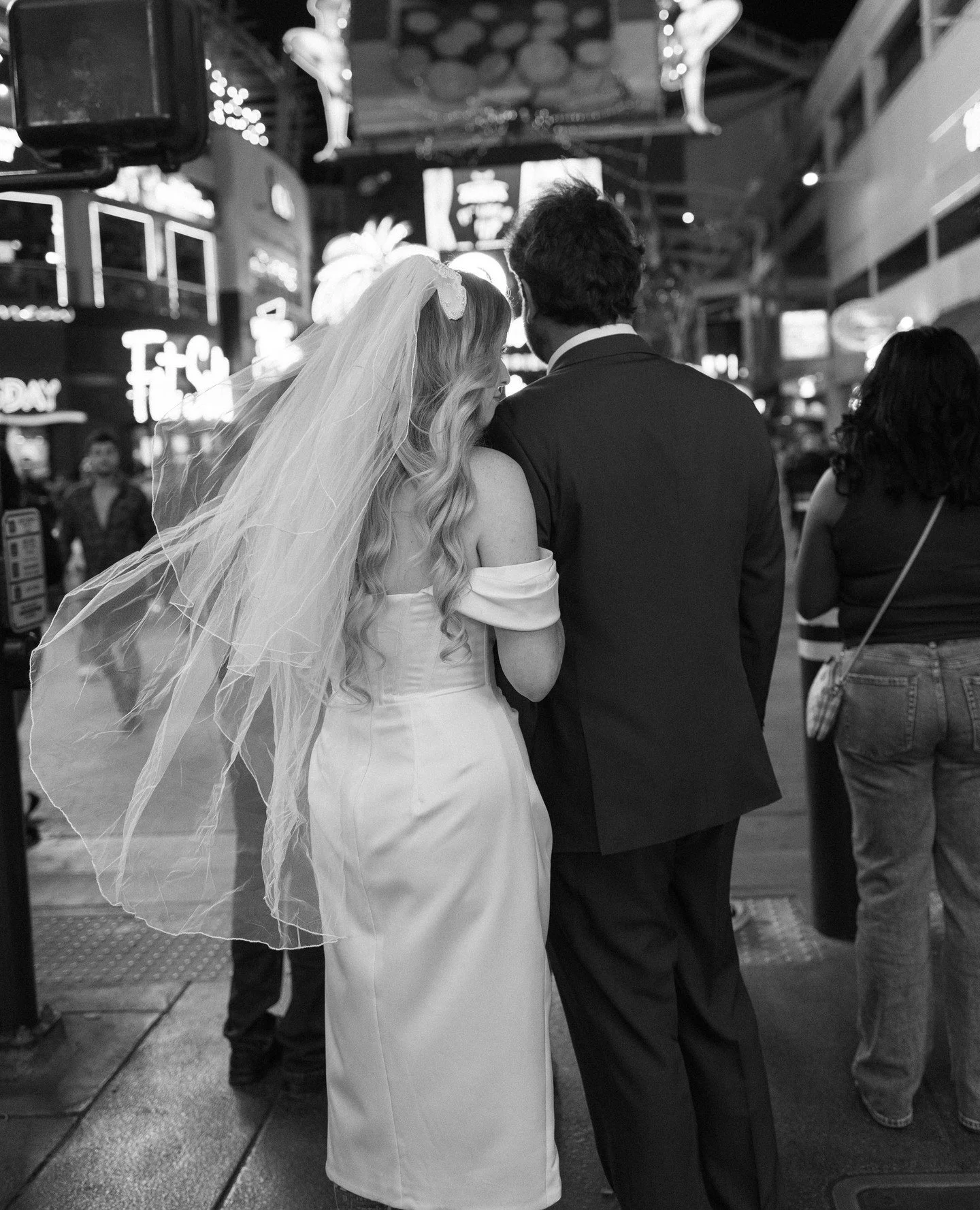 Only in Vegas do you get a moment like this on the way to your reception.⁠
Waiting at a crosswalk with your moms veil blowing everywhere and still looking this good.⁠
Just a red light in Vegas&hellip;⁠
and somehow they made it look romantic.