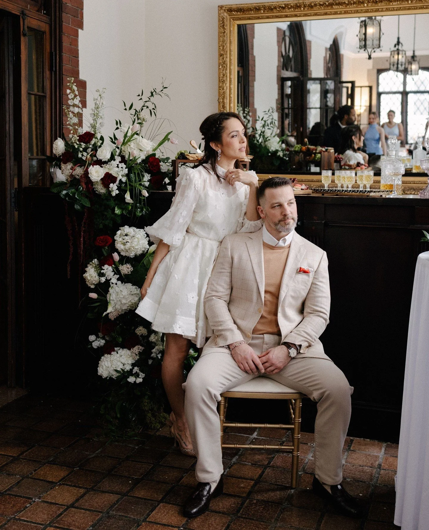 These old spaces at the Saturn Club, spaces always have these little pockets that turn into the best portraits.⁠
Flowers everywhere, a quiet second to breathe, and two people realizing the party is about to start.⁠
#seventharrowstudio #buffalowedding