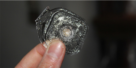 Sometimes multiple glass colors will go into the individual mold, but in this case it's clear glass that will be hand-finished (right) by painting on the back of the glass in a geometric pattern of green and purple , followed by detail painting in a gold-infused paint on the surface. To prepare it for a future pendant, I've removed the shank, mounted it on a soft leather and embroidered the edge with various complimentary beads. I'll finish it once it tells me what I need to do with that fringe. The artists in Jablonec are much more experienced and efficient than me. 
