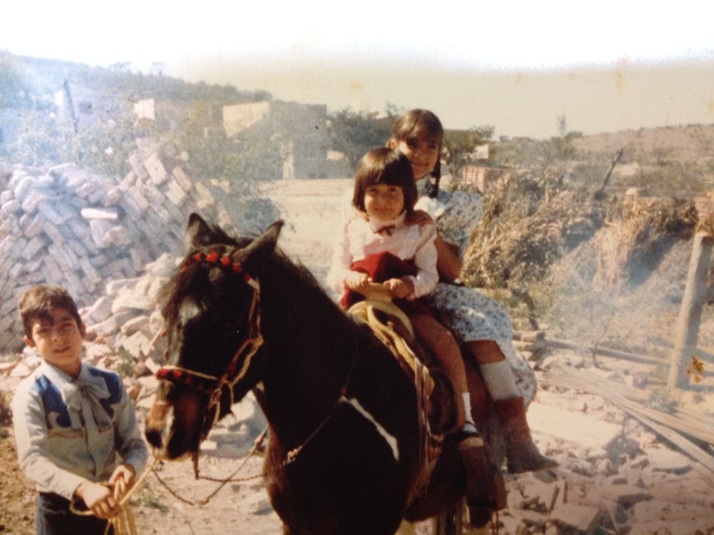 A young Tanya riding a horse.