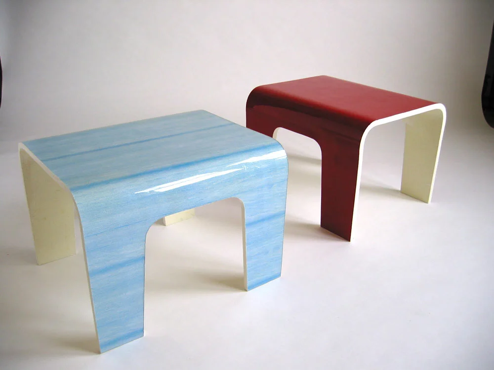 A couple of Derek's coffee tables with a styrofoam core. Derek says: "Ii'm interested in the line between natural and man-made products. The blue table is wood veneer that's been scanned, photoshopped, and re-printed. I called it 'faux fir'." 