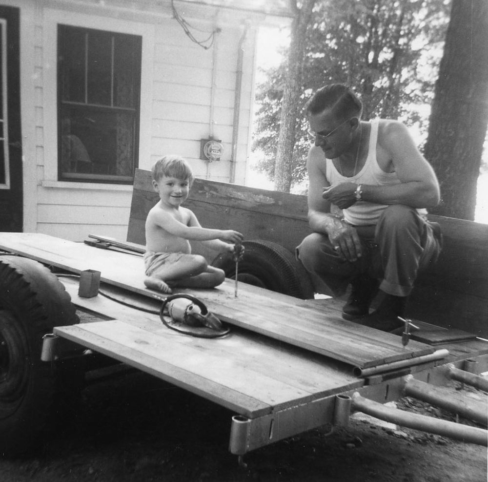 Norm as a youngster working with his grandfather on their trailer
