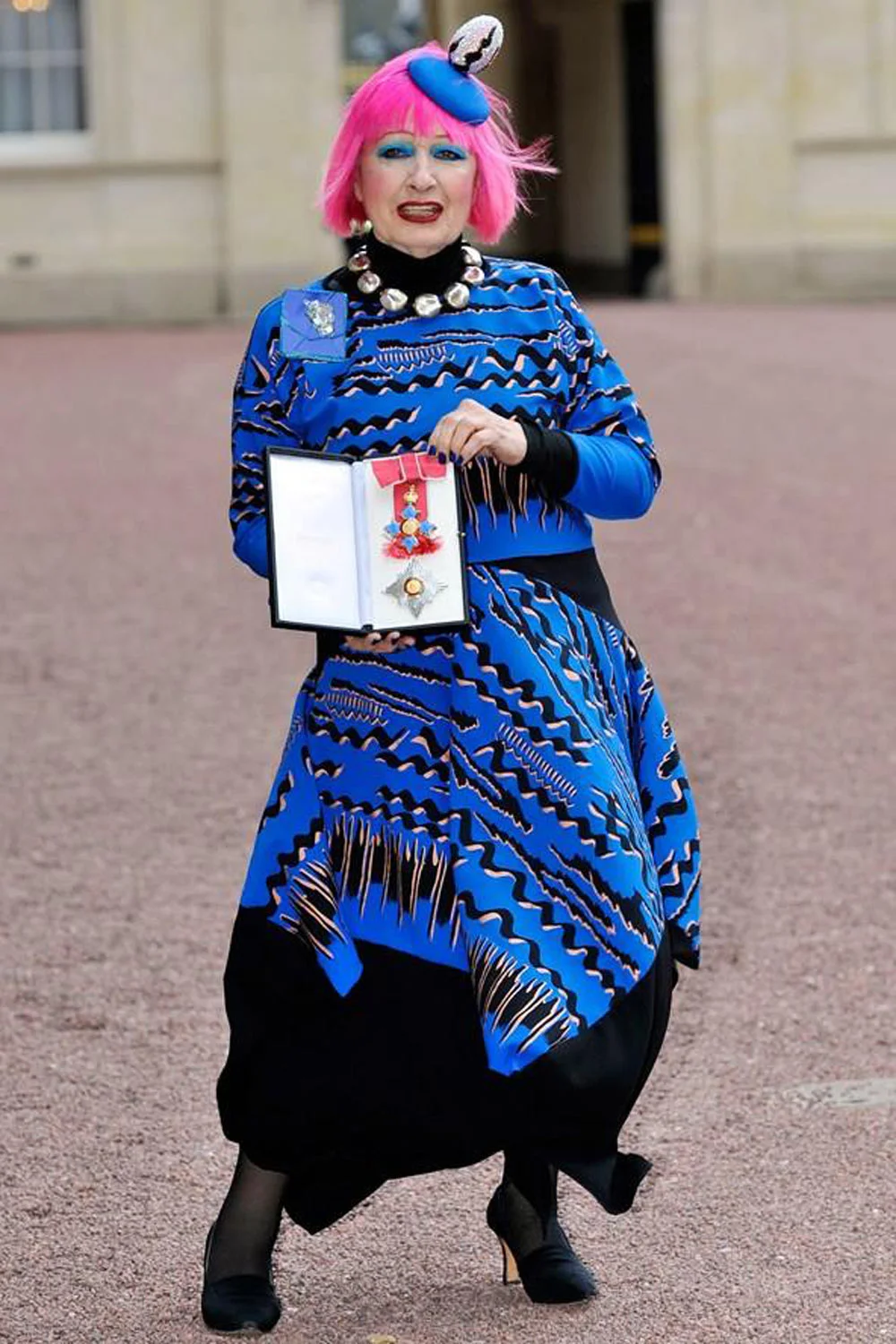 Showing medal at Buckingham Palace when made Dame.