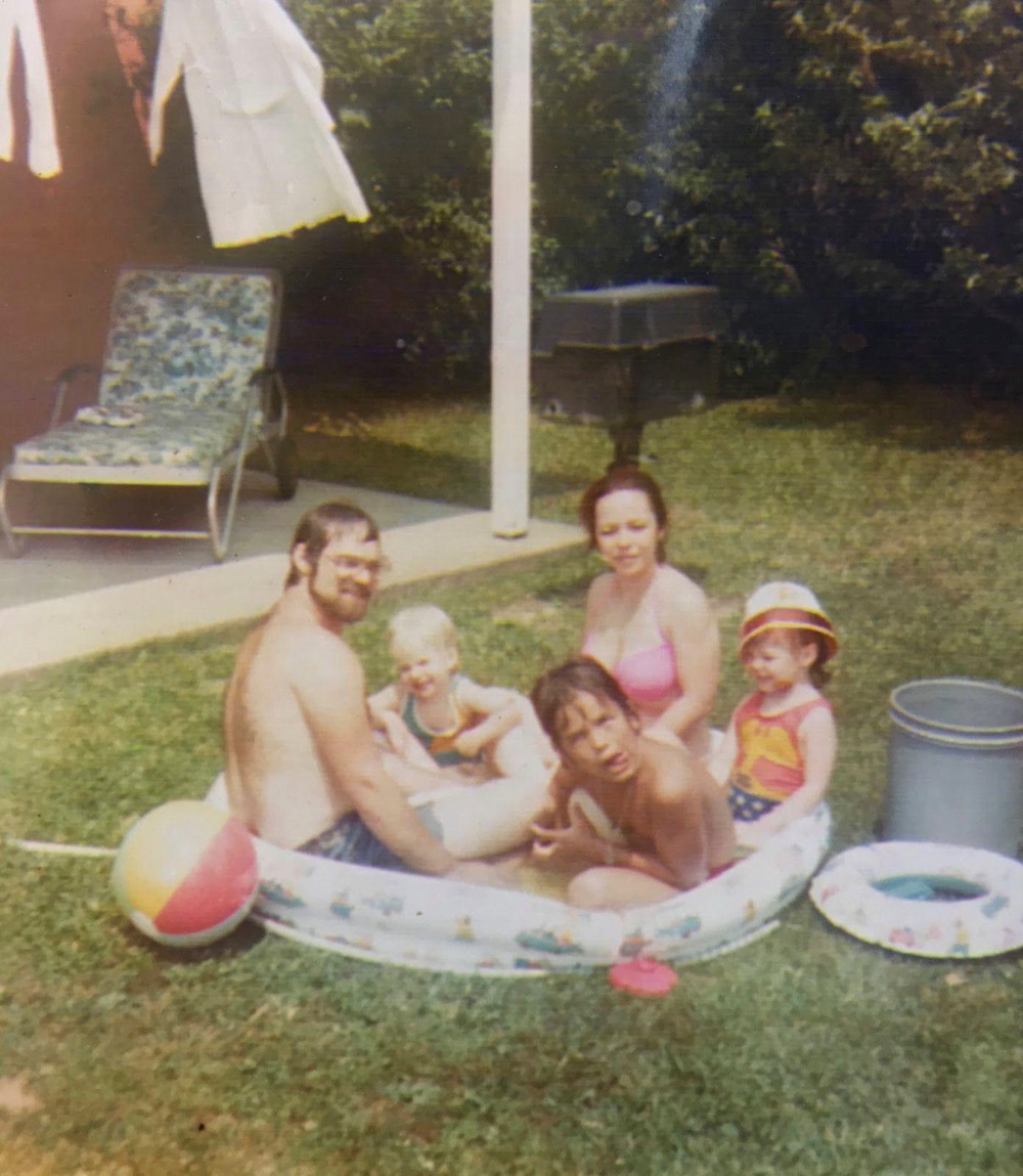 With his family - "Sitting between my mom and dad, brother Joe making the screw face, and my sis Jolie as Wonder Woman"