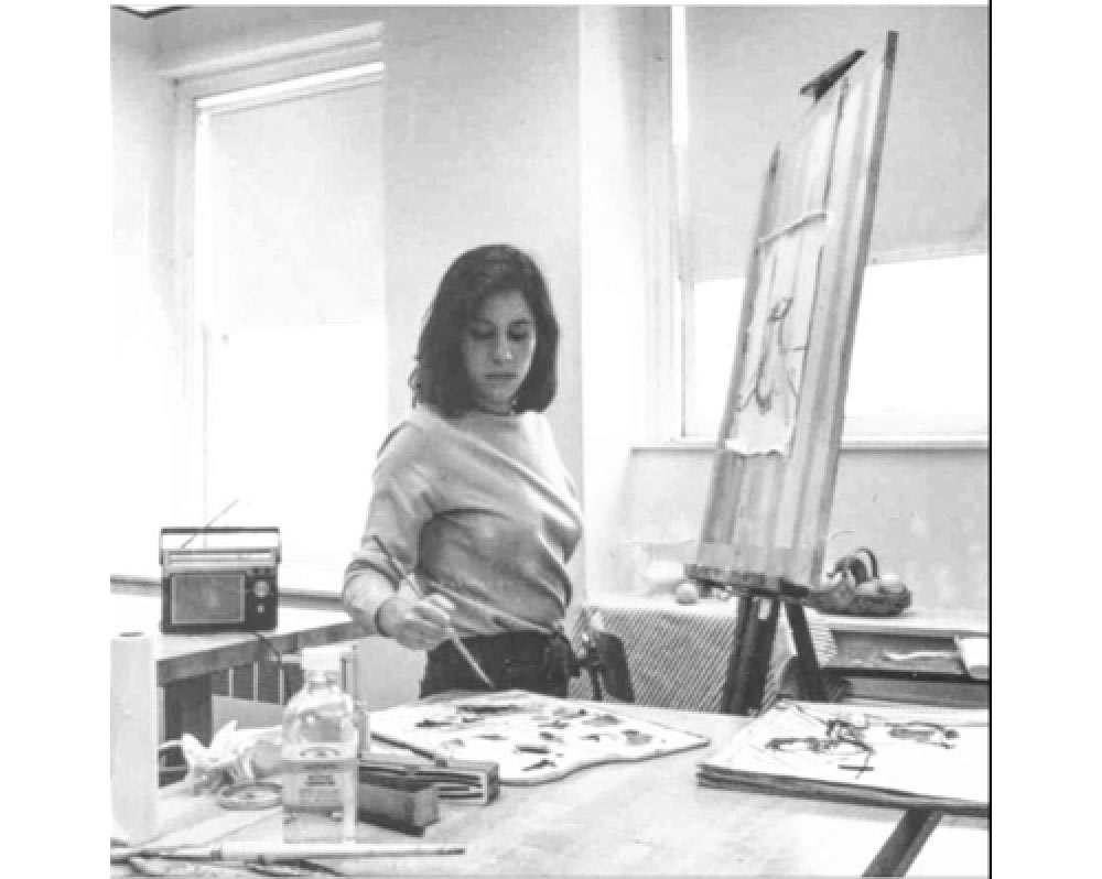 Young Madeline painting in the studio