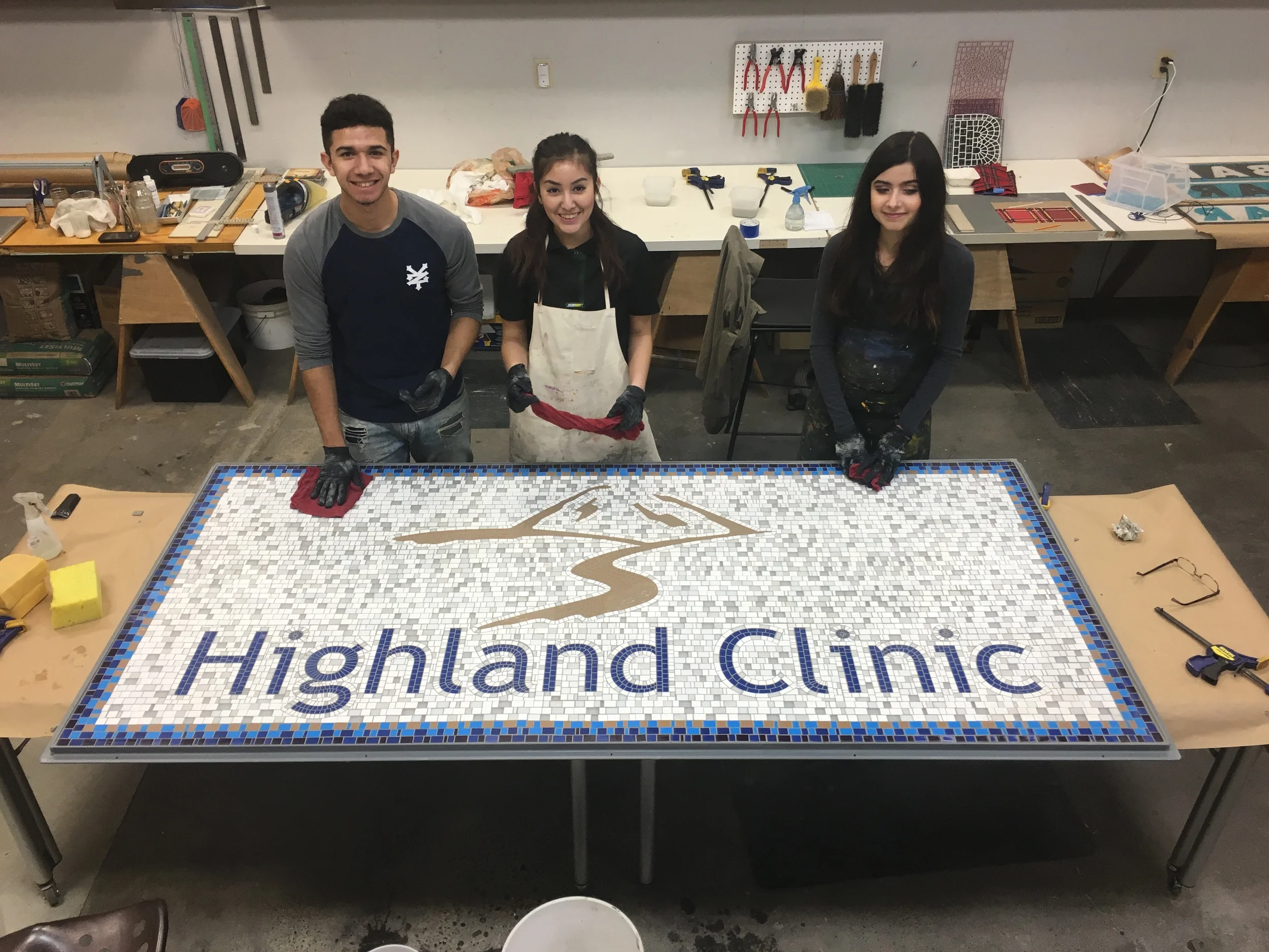 The finished sign with studio apprentices Saul, Lilly and Amparo