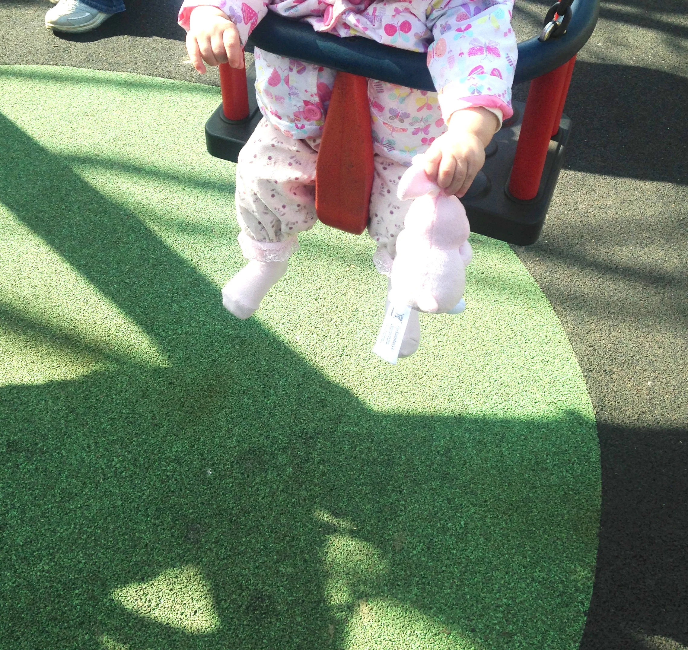 My niece and her easter bunny on the swings. 