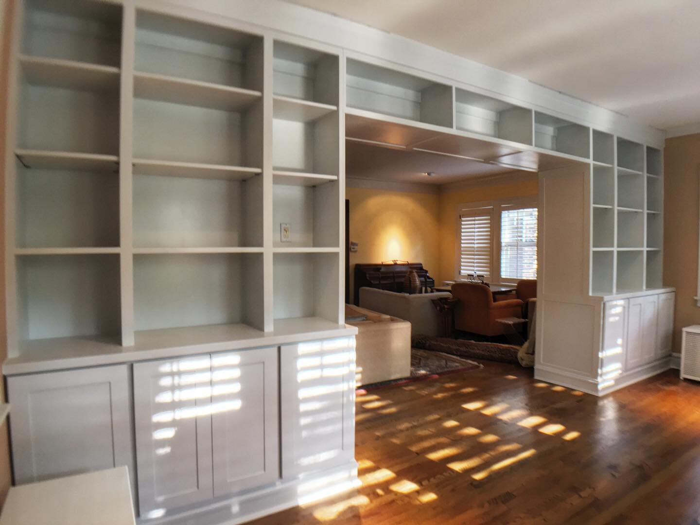 When our clients asked how we could help them create a good-looking space for their huge collection of books, we answered with a 15&rsquo; wall-to-wall built-in bookcase with Shaker style doors &amp; paneling. 

We all agree: problem solved. 

#custo