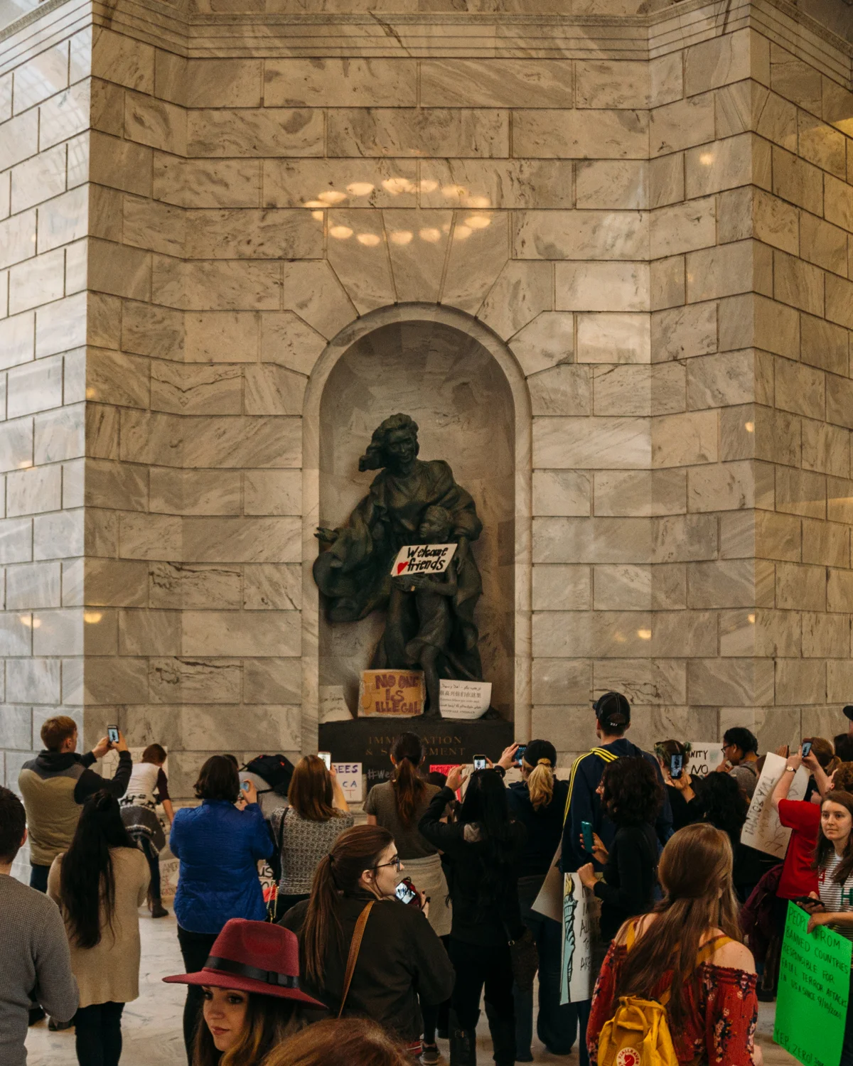 A halo rests above the Immigration & Settlement statue.
