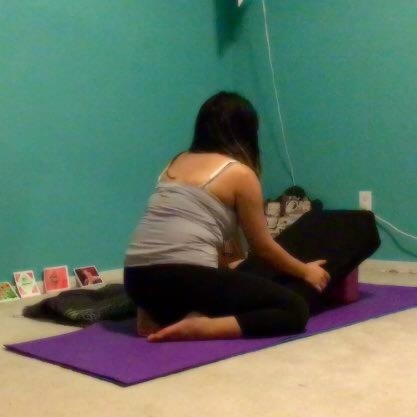 Use a bolster and block to set up for restorative yoga