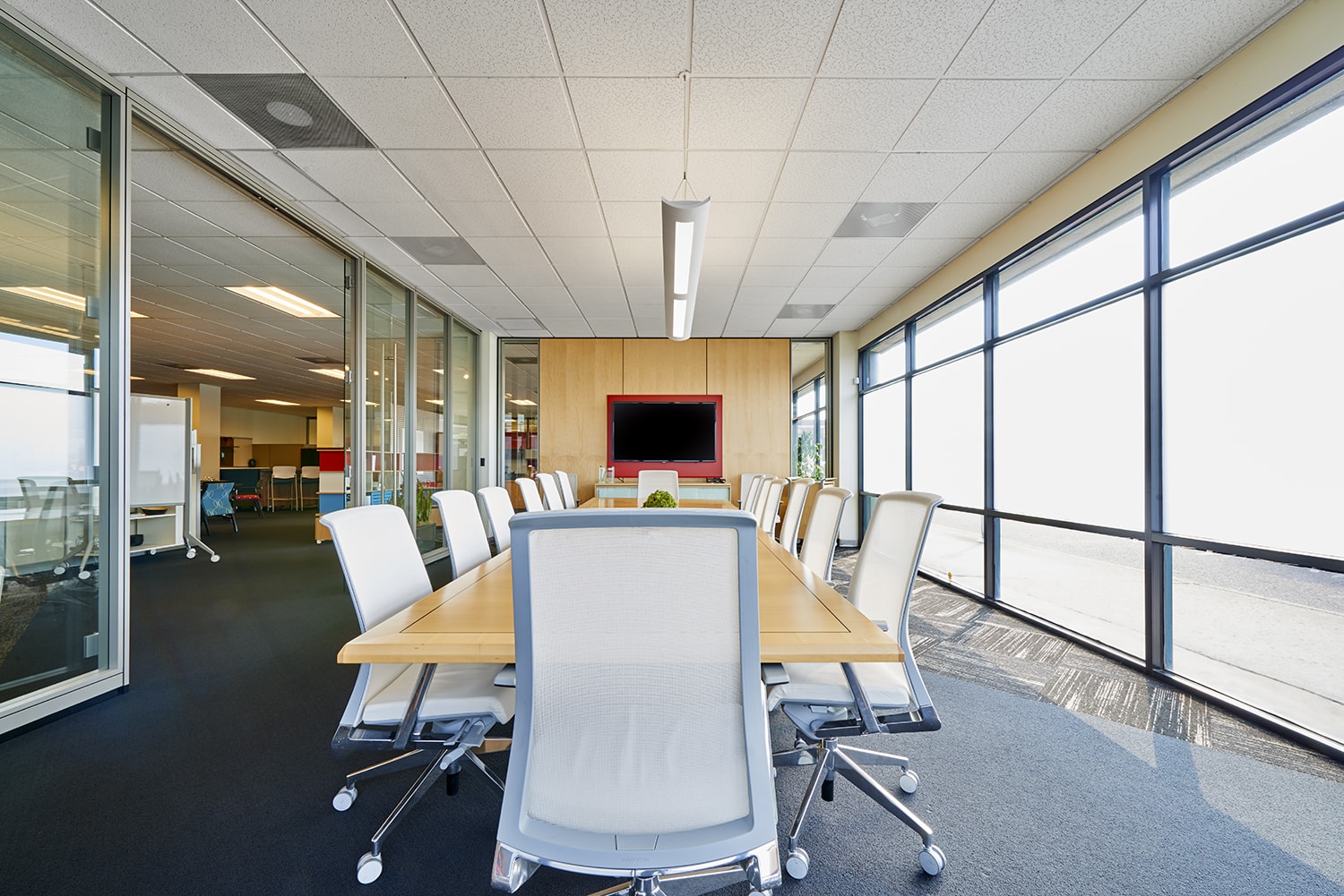 Brightly lit modern conference room with large windows