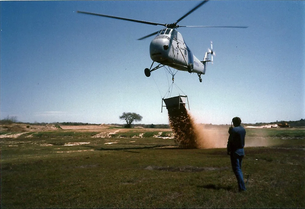 Helicopter Dumps Sand on Bog