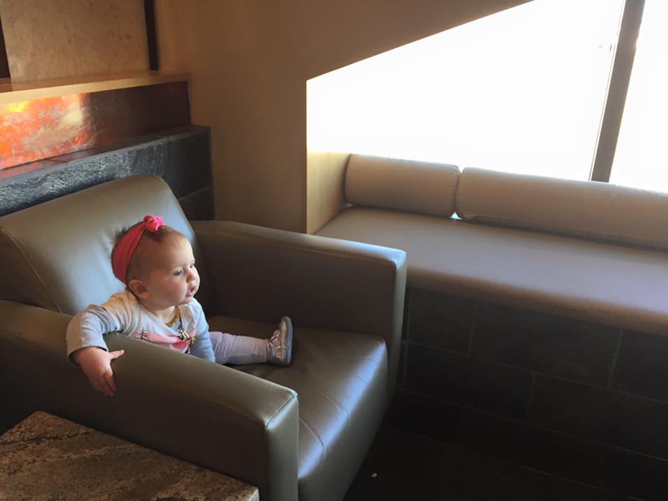 Here is our daughter enjoying comforts of the Delta Sky Lounge in Atlanta