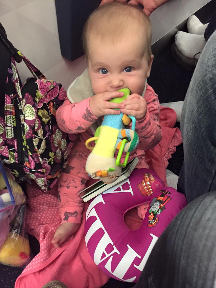 Playing on the floor of the plane during our ground delay in Paris