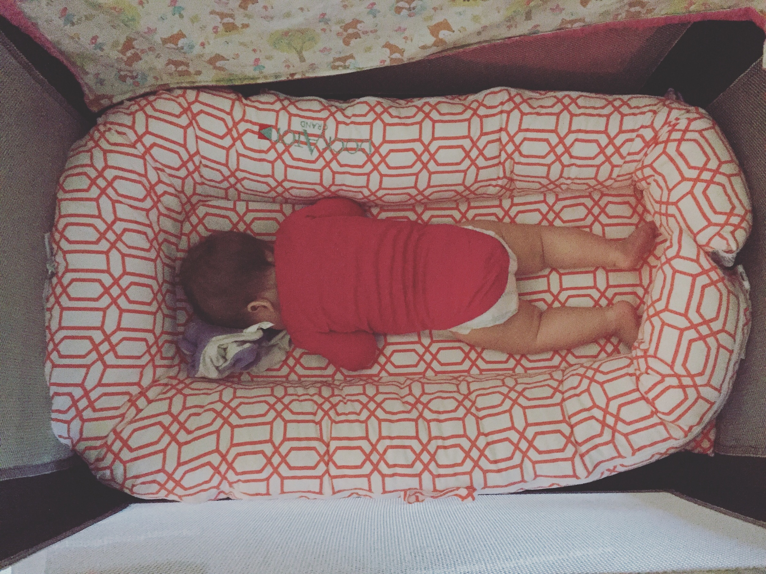 Our daughter using her Dock-A-Tot grande in a pack-n-play in a hotel in Tucson, Arizona -- she took 3 hour naps and slept through the night this trip!!