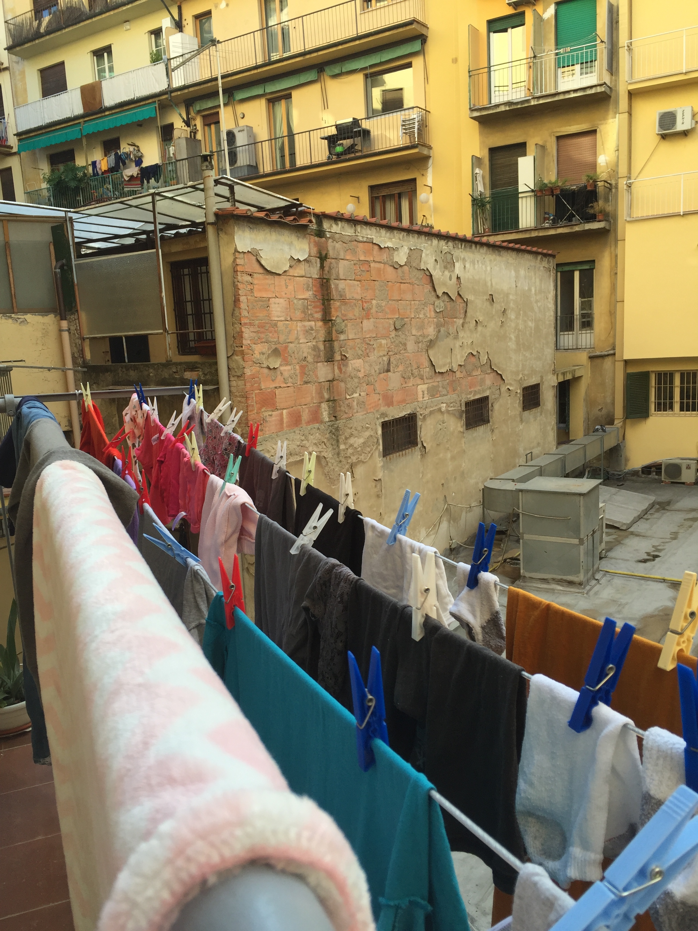 View to the courtyard from our Kitchen balcony -- we felt like locals with our clothes hanging to dry!! WE LOVED IT!! Florence, Italy