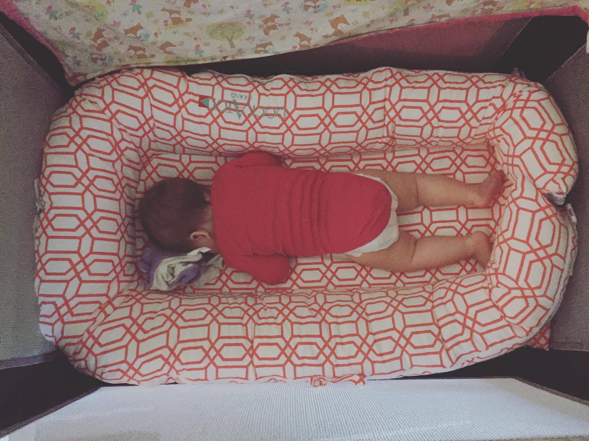 Charletta at 9 months in a standard pack n play with DockaTOT grand