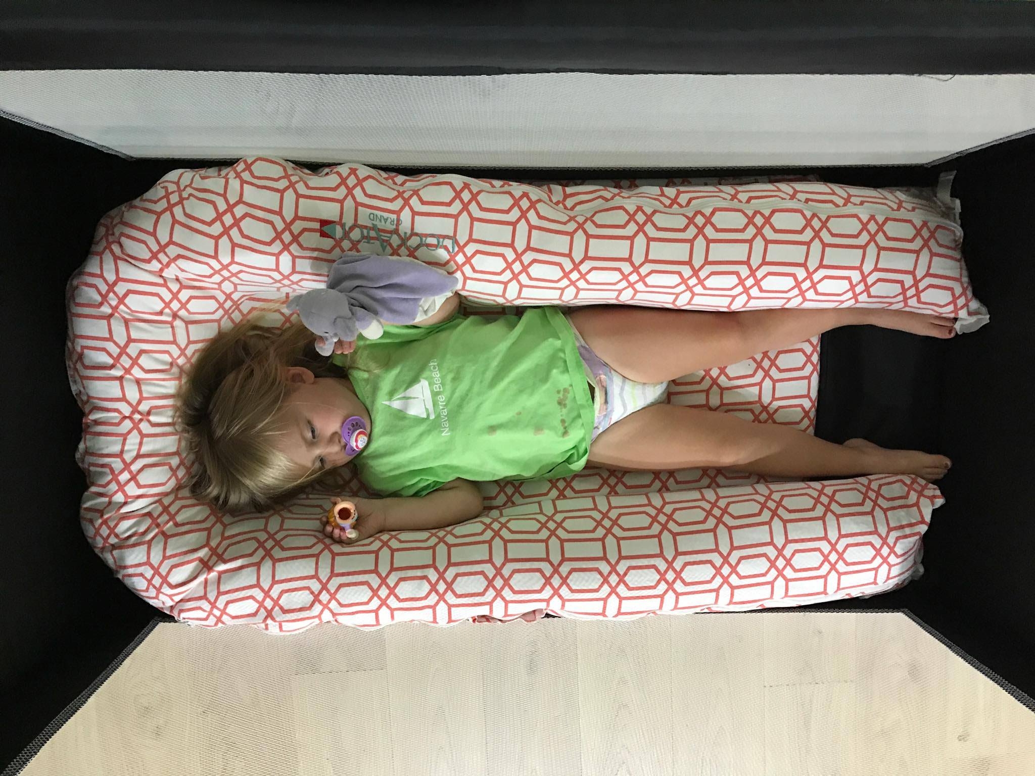 Charletta at 2 years, 4 months in an extended length travel cot -- she can fully extend her legs and sleep on her stomach. (also, don't pay attention to her stained tshirt)