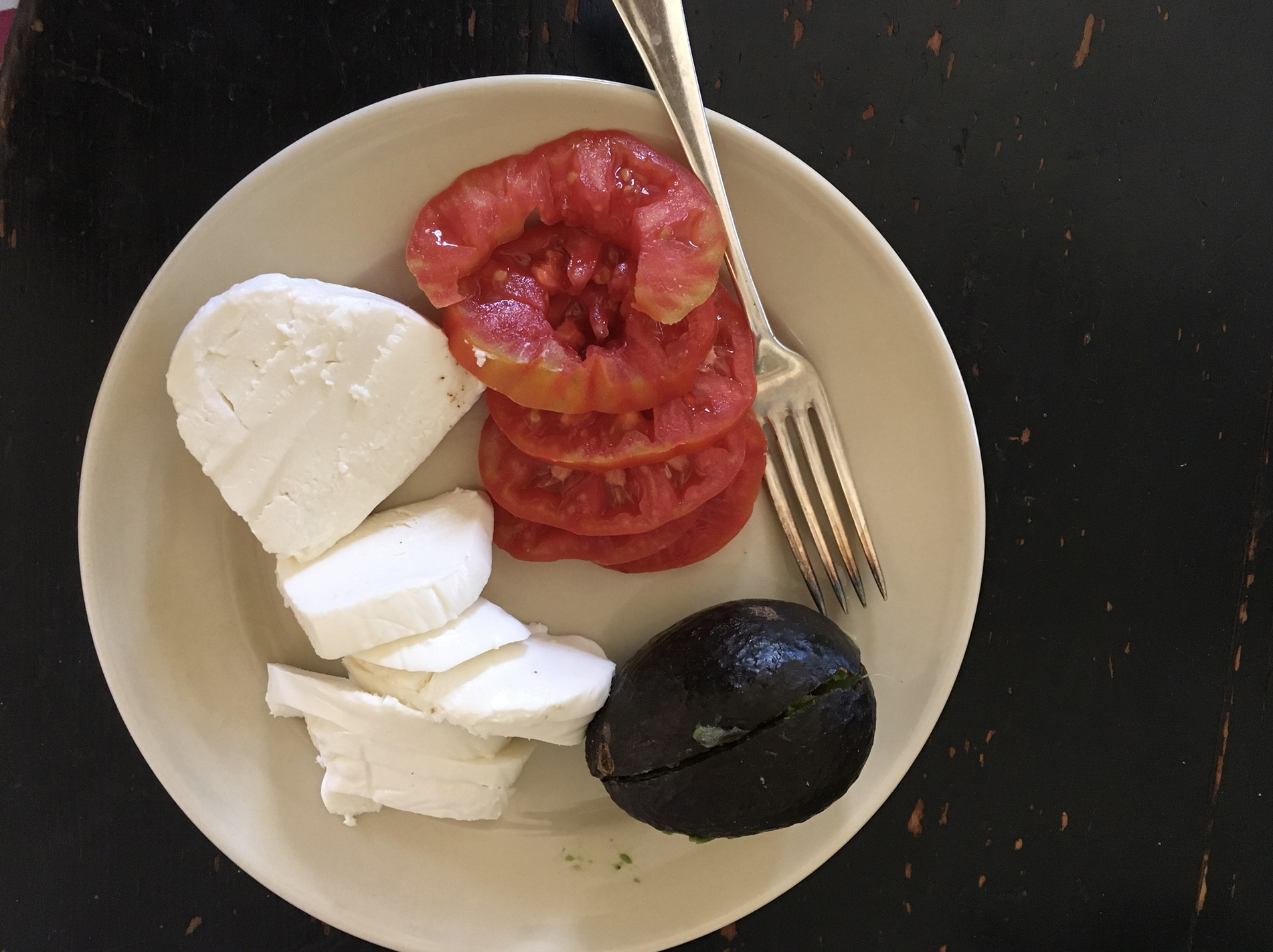 A very, very ripe tomato and avocado caught in the nick of time with fresh mozzarella. 