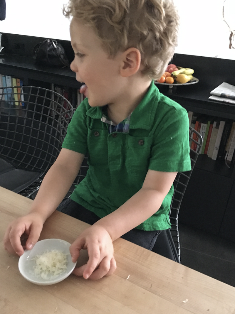 Alex, tasting his ingredient prior to using it. He loves fresh parmesan. 