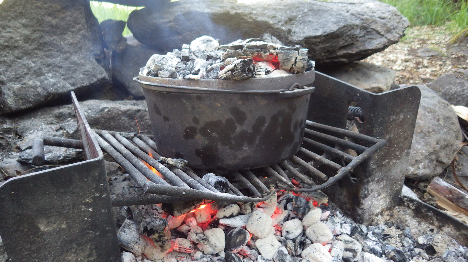 Dutch Oven Biscuits baking over an open flame. 
